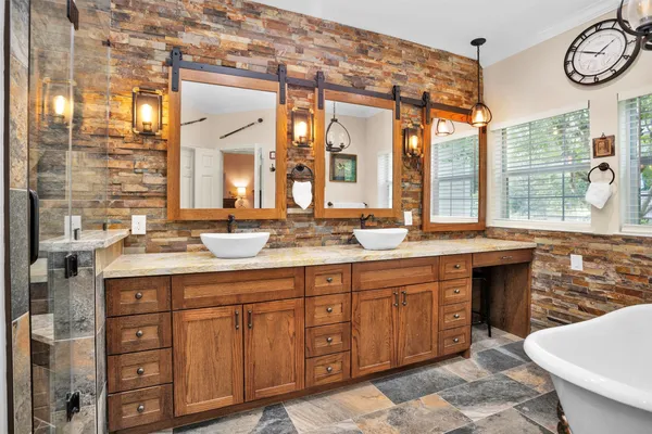 a bathroom with a granite countertop sink and a large mirror