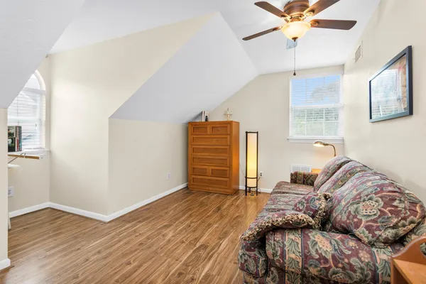a living room with furniture ceiling fan and a rug