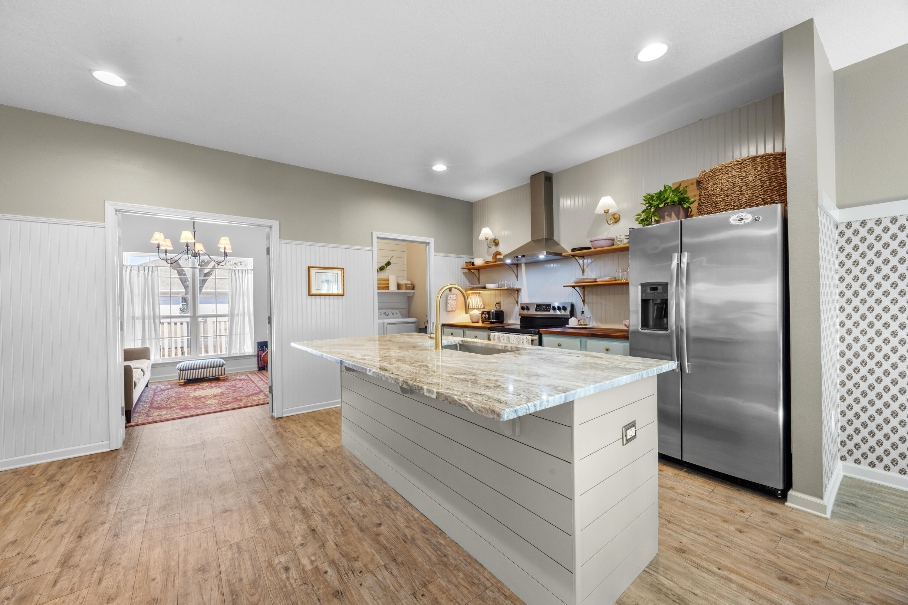 110 Cornelia Street Freeport, FL 32439 - Photo 14 of 60 a kitchen with stainless steel appliances granite countertop a refrigerator a stove and a wooden floors