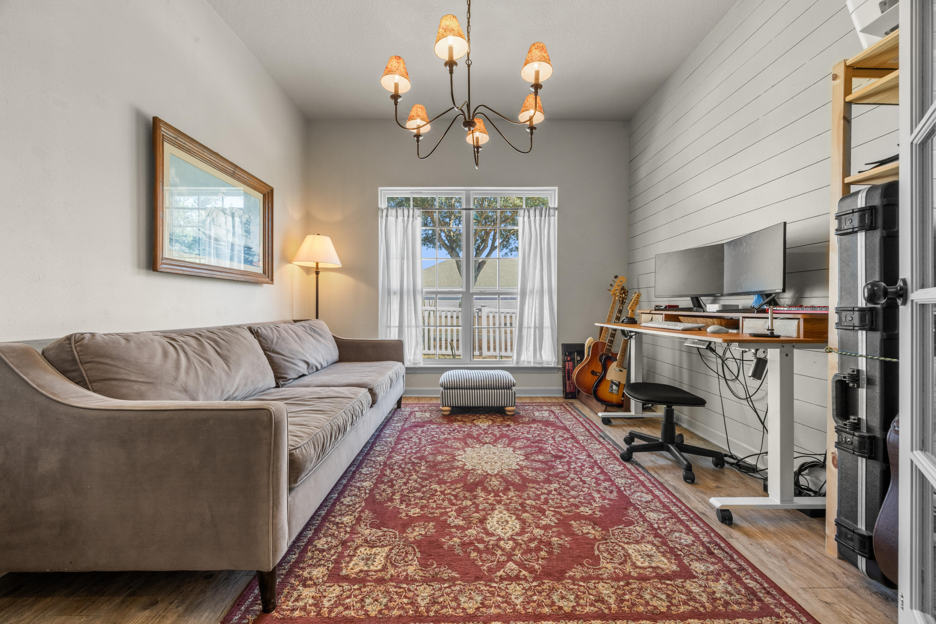 110 Cornelia Street Freeport, FL 32439 - Photo 17 of 60 a living room with furniture a rug and a chandelier