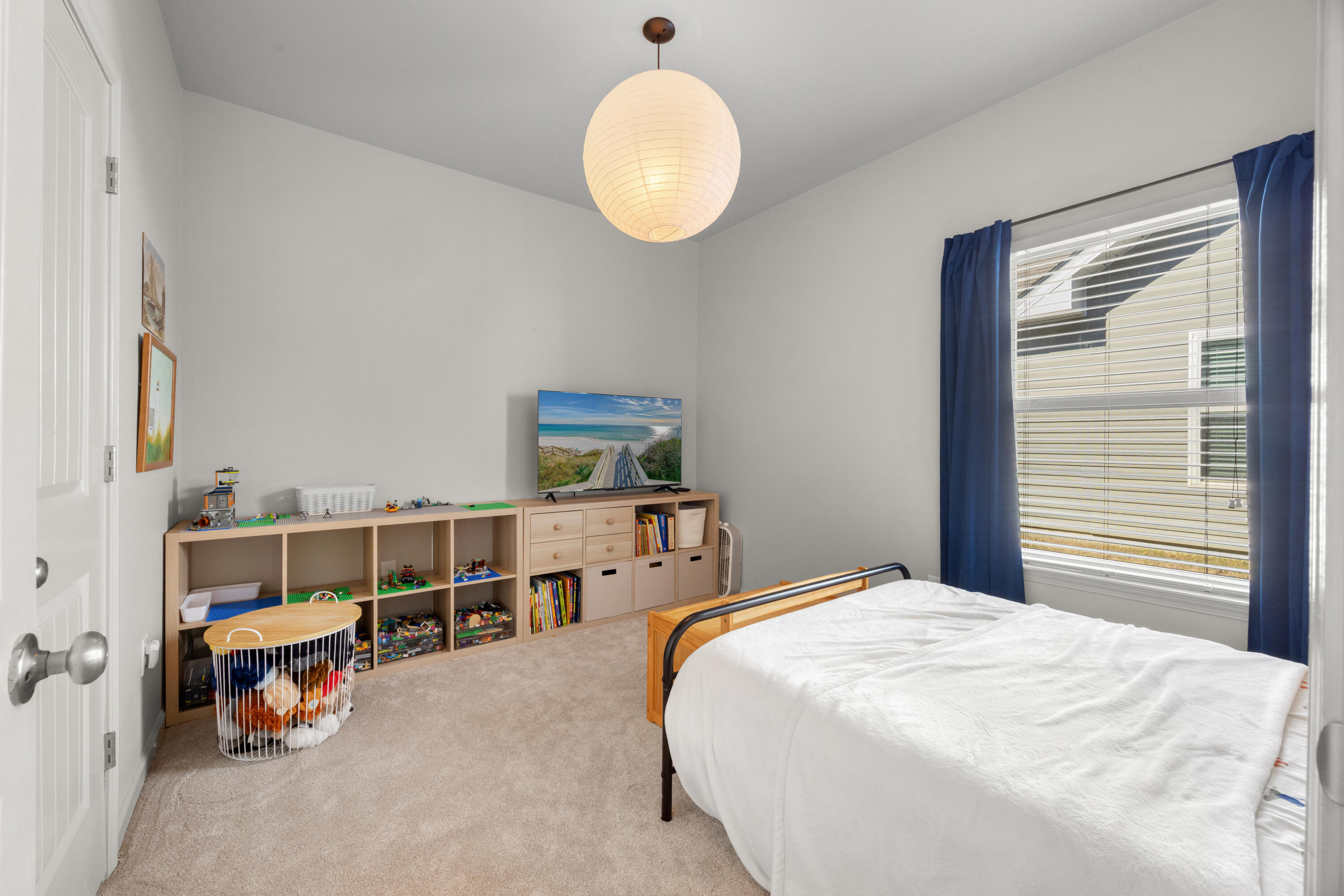 110 Cornelia Street Freeport, FL 32439 - Photo 25 of 60 a bedroom with a bed and a chandelier