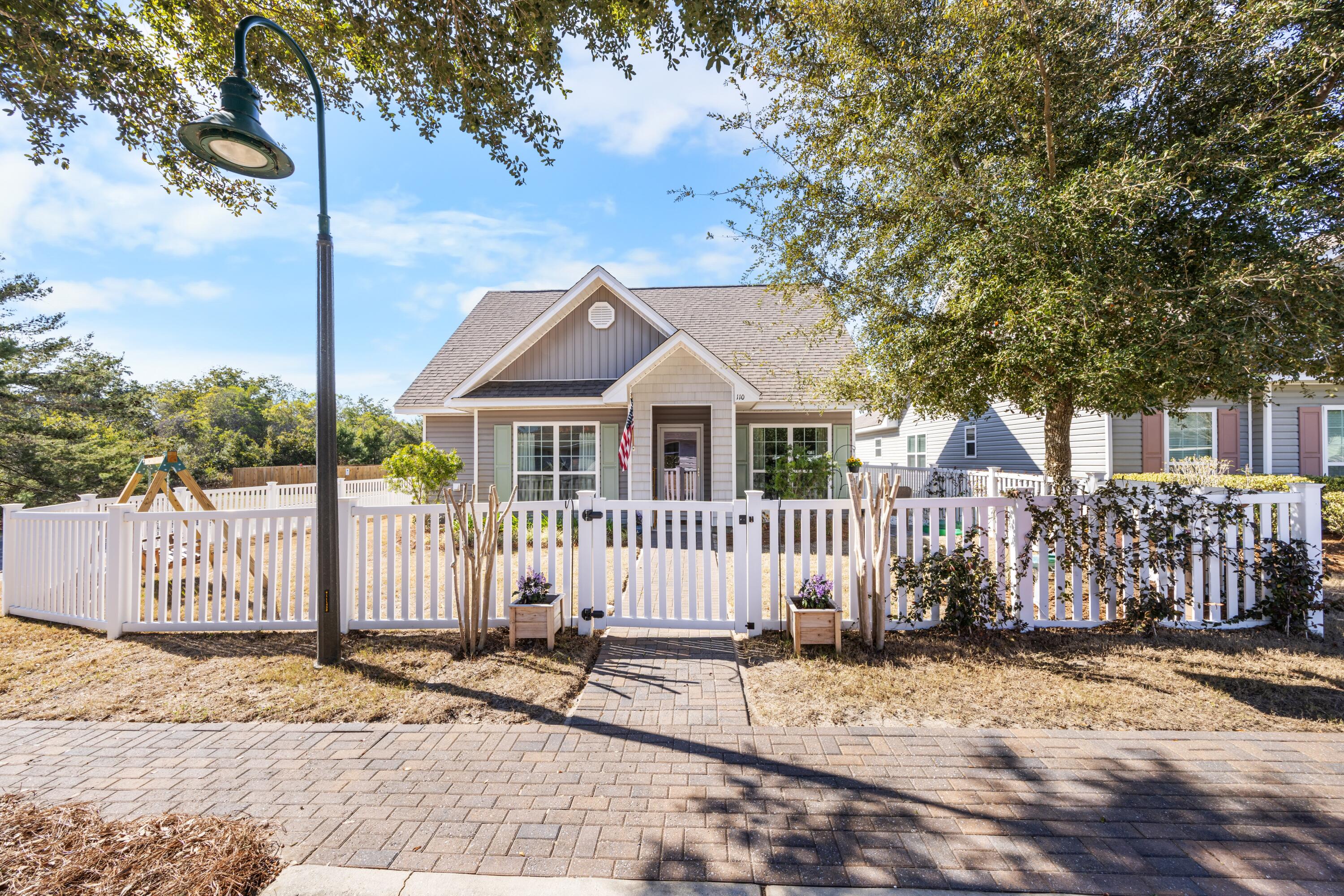 110 Cornelia Street Freeport, FL 32439 - Photo 3 of 60 a front view of a house with a garden
