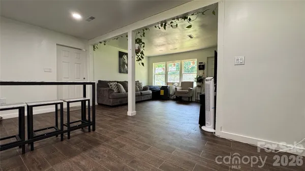 a view of a livingroom with furniture and hardwood floor