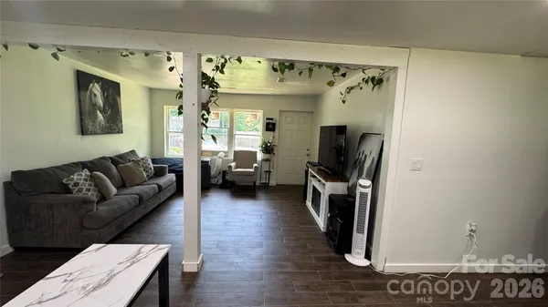 a living room with furniture and a chandelier