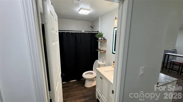 a bathroom with a toilet and a shower