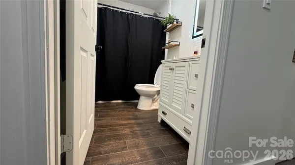 a bathroom with a toilet and a shower