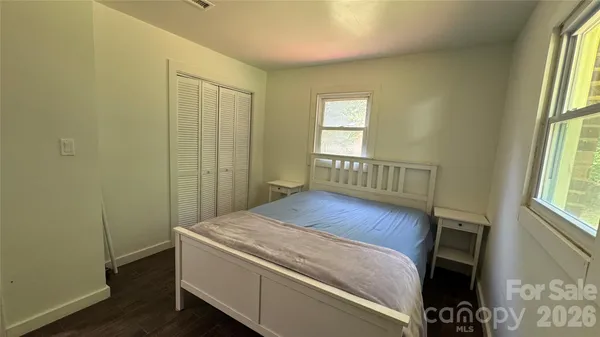 a bed sitting in a bedroom next to a window