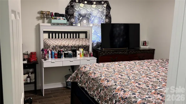 a bedroom with a bed and a television