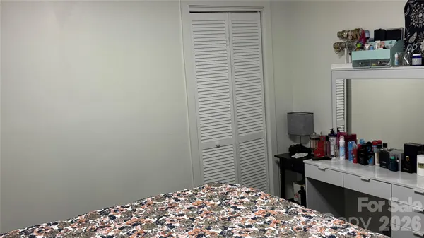 a bedroom with a bed and a table in it