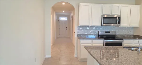 a kitchen with stainless steel appliances granite countertop a stove and a microwave