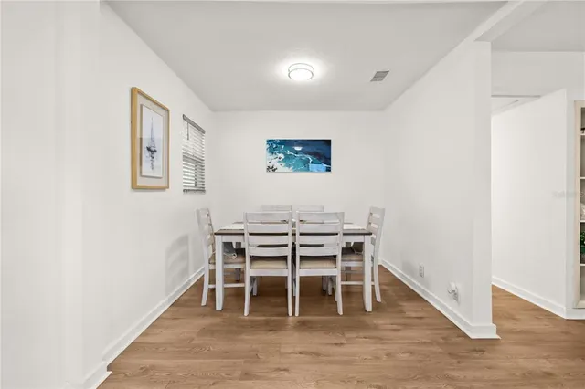 a view of a workspace with furniture and wooden floor