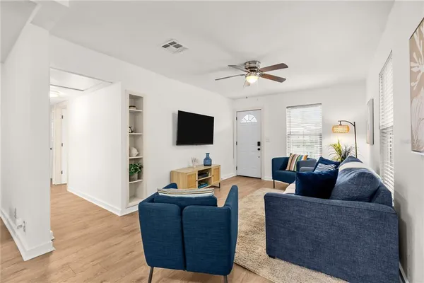 a living room with furniture and a flat screen tv