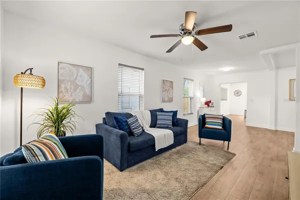a living room with furniture and a chandelier