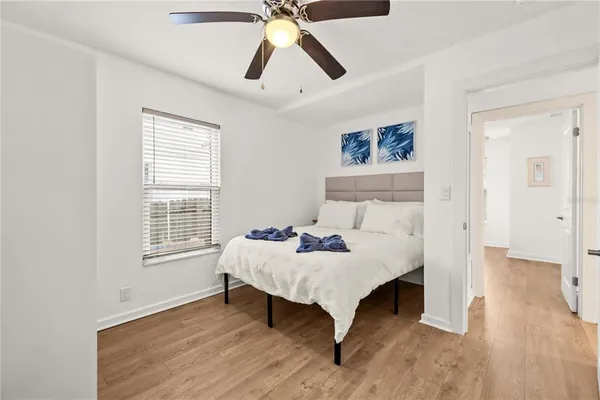 a bedroom with a bed and a chandelier
