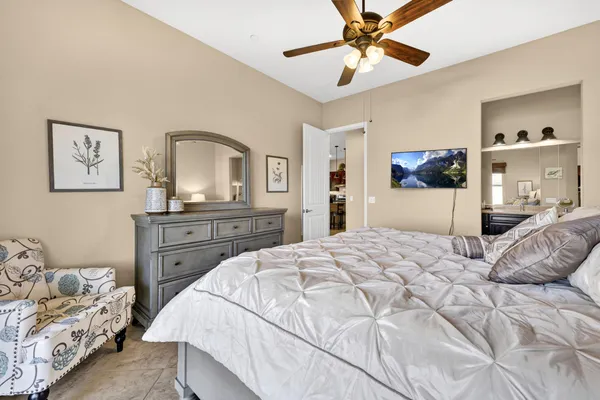 a bedroom with a bed and a chandelier