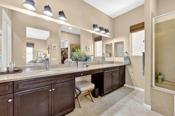 a spacious bathroom with a sink double vanity and a mirror