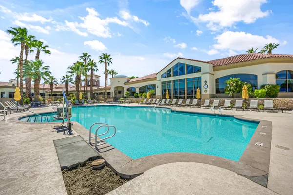 swimming pool view with a seating space and a garden view