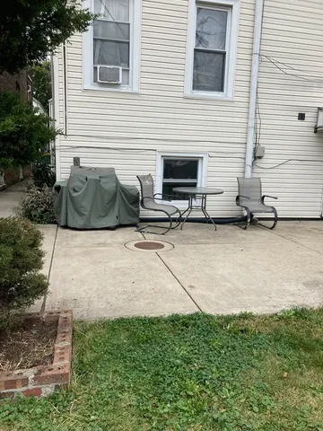 a view of a house with a yard and sitting area