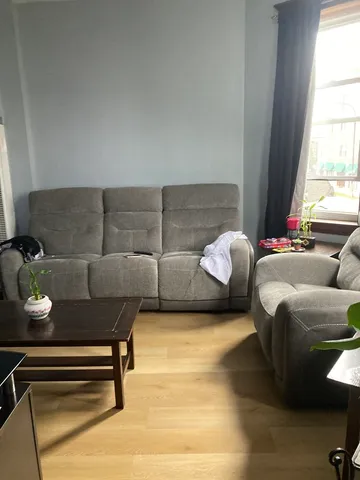 a kitchen with a table chairs stove and refrigerator