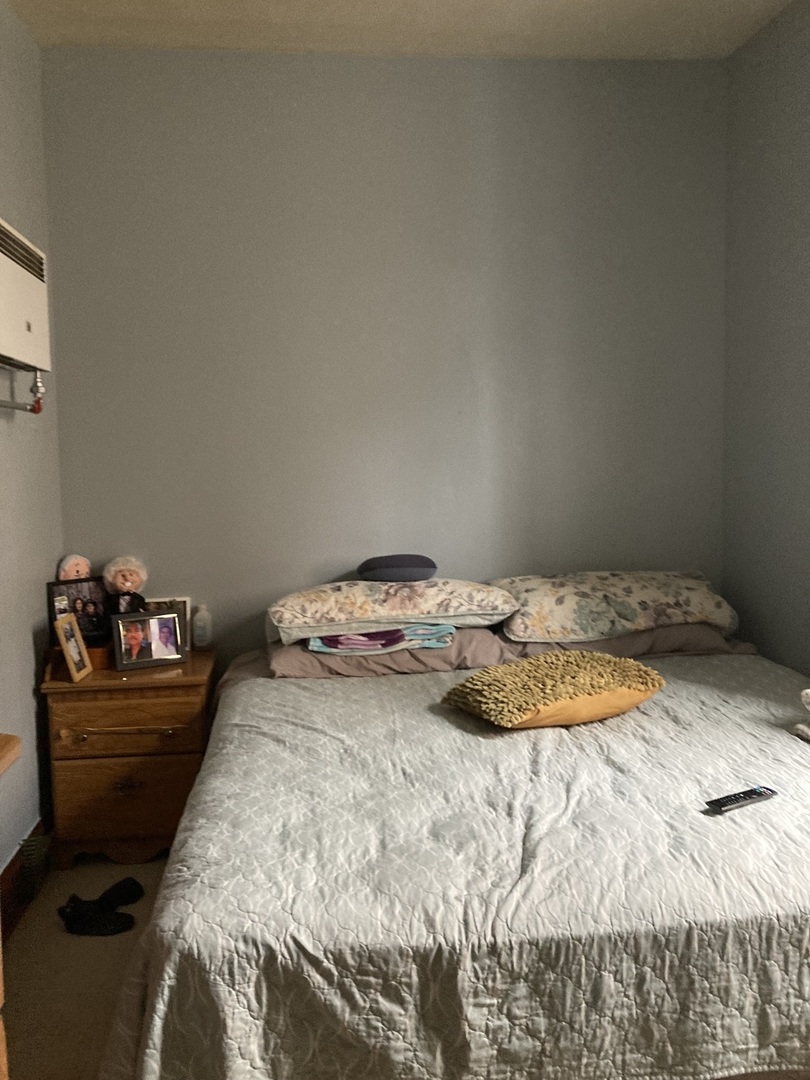 2239 South Central Avenue Cicero, IL 60804 - Photo 6 of 10 a bedroom with a bed and dresser