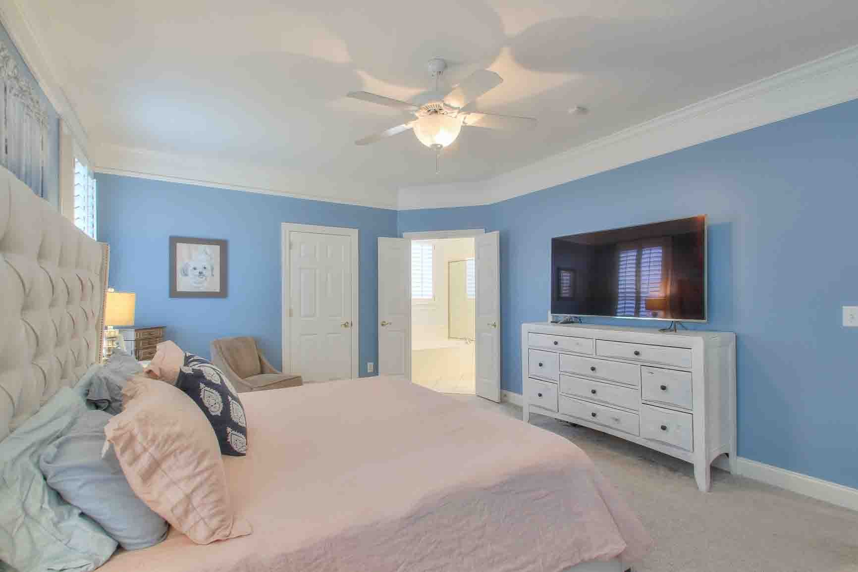 206 Polk Pl Drive Franklin, TN 37064 - Photo 21 of 47 a bedroom with a large bed and a flat tv screen on dresser