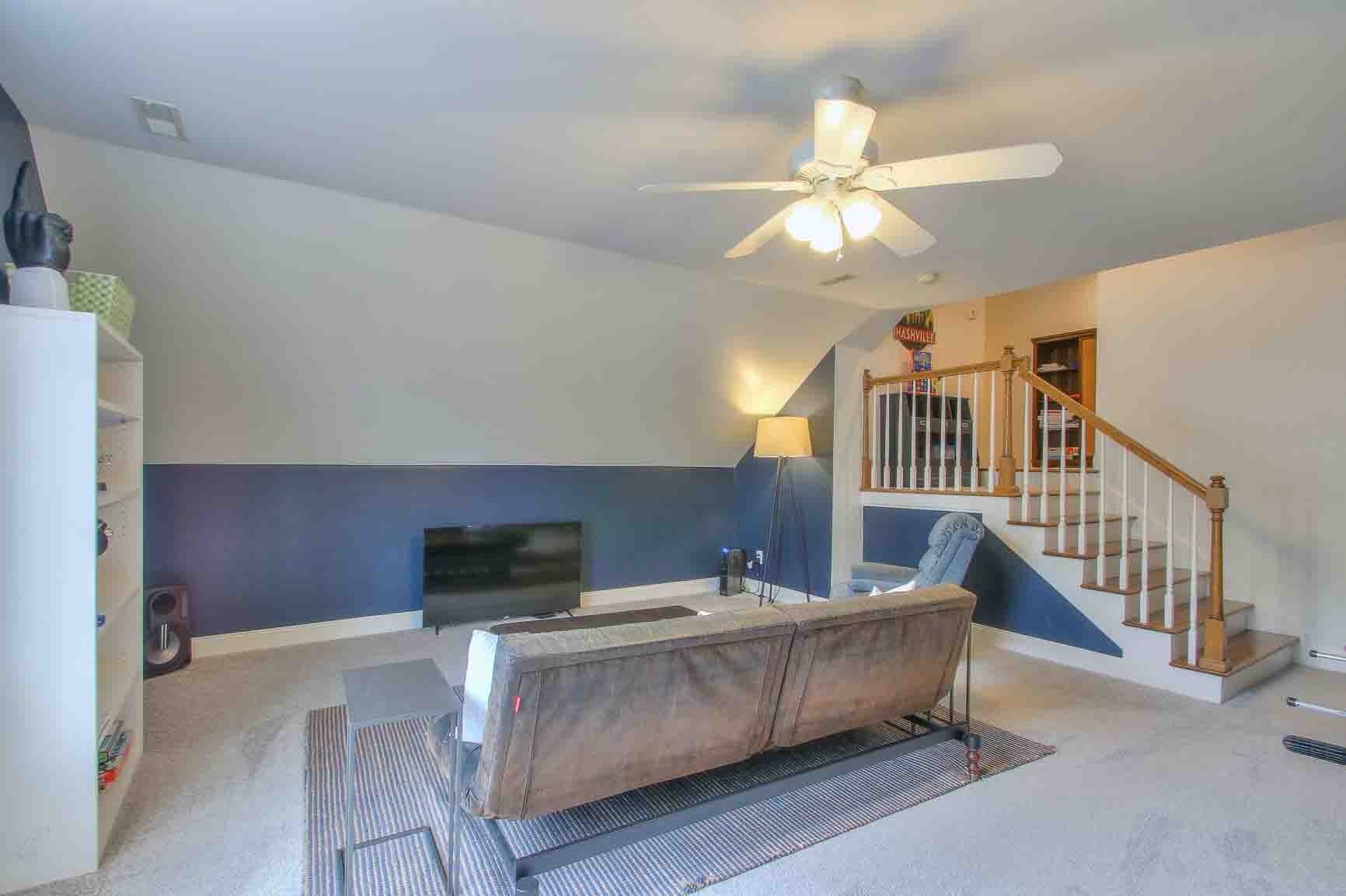 206 Polk Pl Drive Franklin, TN 37064 - Photo 35 of 47 a living room with furniture and a chandelier