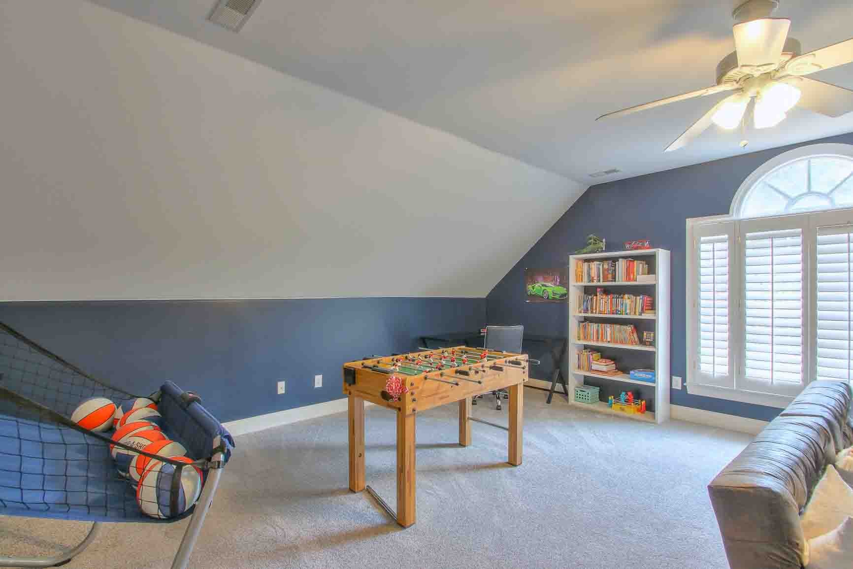 206 Polk Pl Drive Franklin, TN 37064 - Photo 37 of 47 a living room with furniture a bookshelf and a window