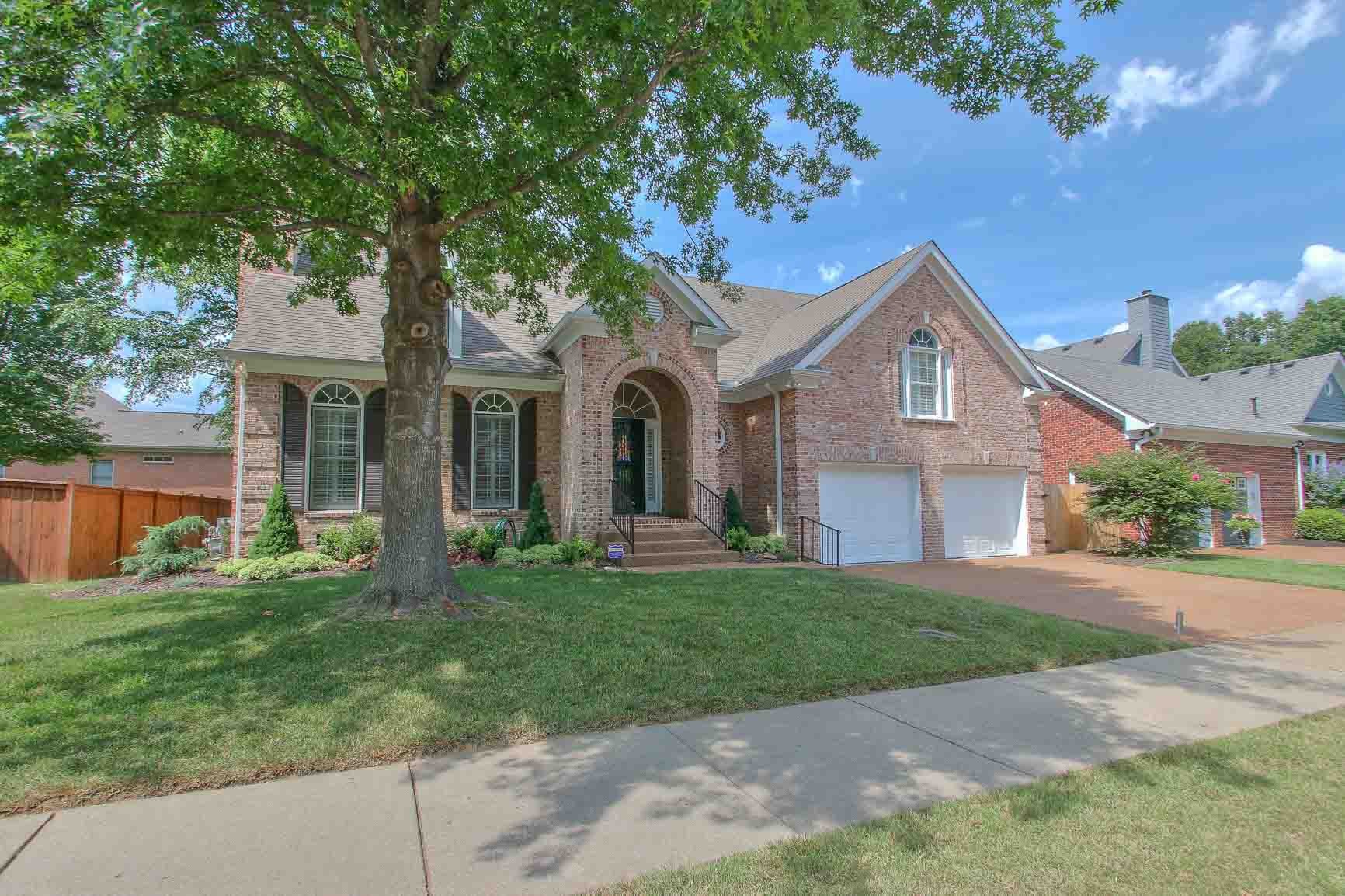 206 Polk Pl Drive Franklin, TN 37064 - Photo 44 of 47 a front view of a house with a garden and yard