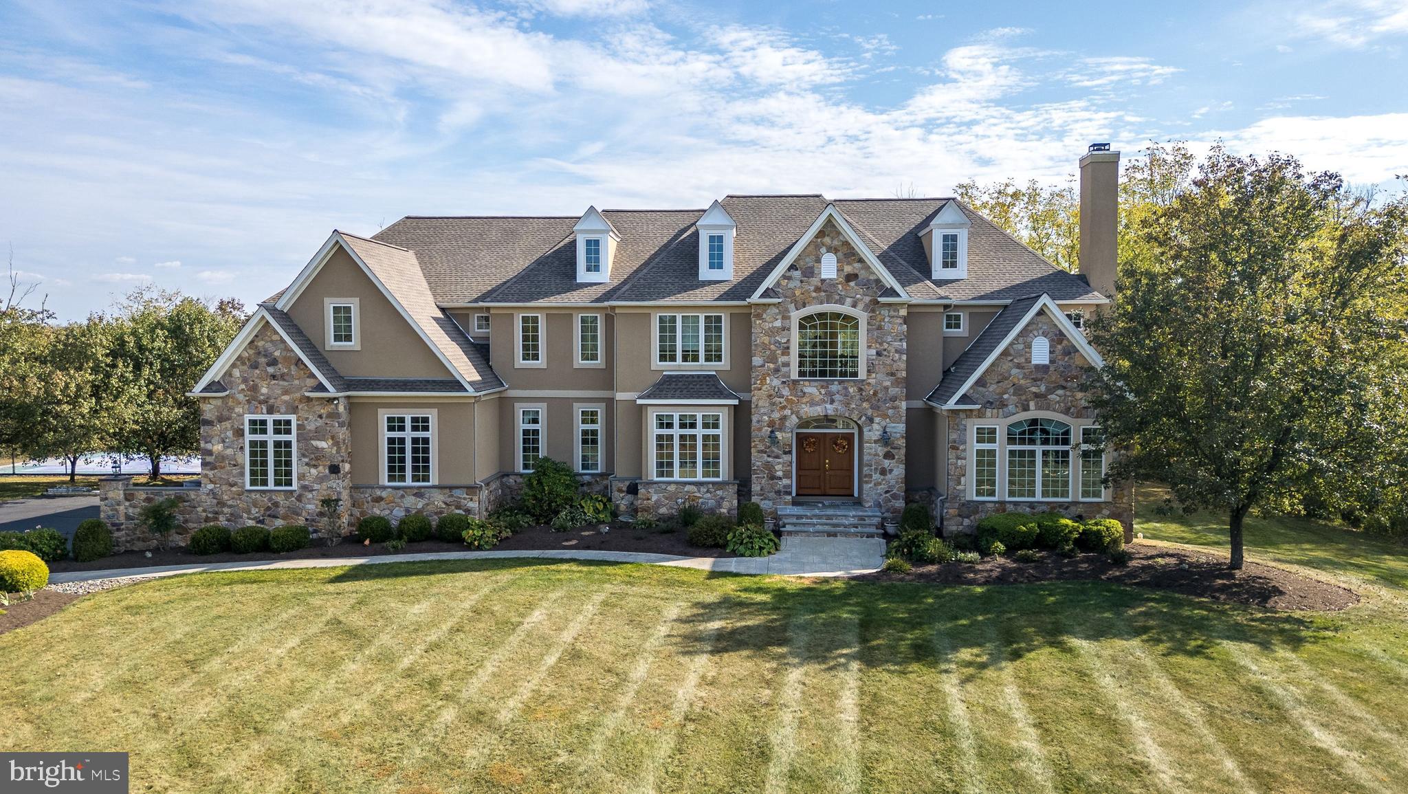 a front view of house with yard and trees around