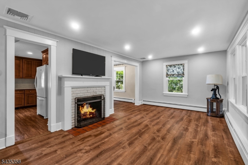105 Somerville Road Bedminster, NJ 07921 - Photo 4 of 36 a view of empty room with wooden floor fireplace and window