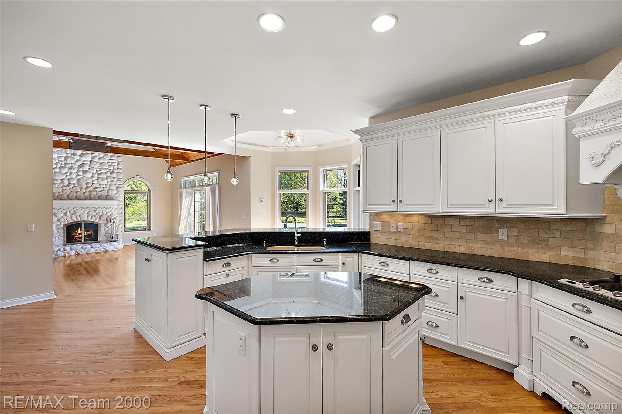 630 Sheldon Court Rochester, MI 48306 - Photo 27 of 94 Kitchen with a peninsula, dark stone counters, and a kitchen island