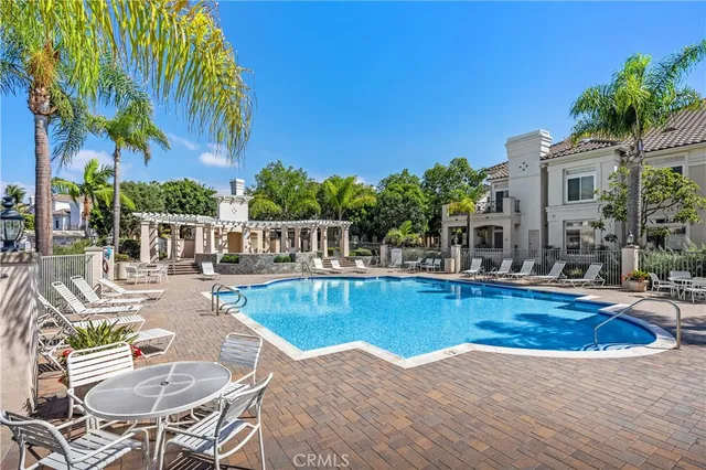 a view of swimming pool with outdoor seating and plants