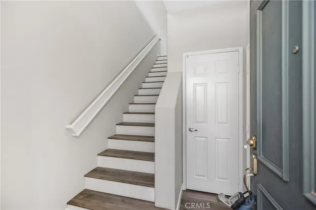 a view of entryway with wooden floor and stairs
