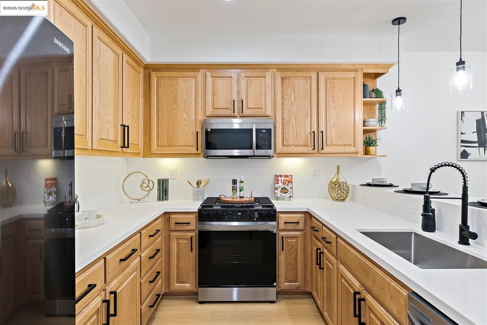 4153 Clarinbridge Circle Dublin, CA 94568 - Photo 13 of 60 a kitchen with stainless steel appliances granite countertop a stove a sink and a microwave