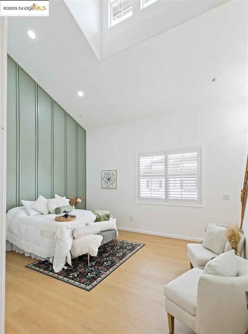 4153 Clarinbridge Circle Dublin, CA 94568 - Photo 20 of 60 Bedroom featuring multiple windows, light wood-style flooring, recessed lighting, and a decorative wall