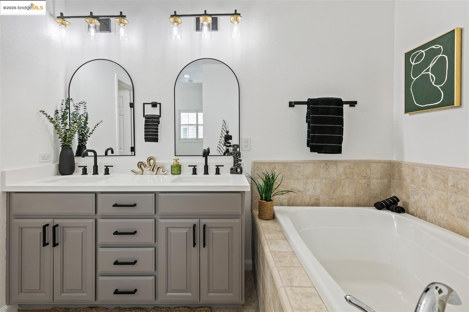 4153 Clarinbridge Circle Dublin, CA 94568 - Photo 27 of 60 a bathroom with a granite countertop sink a mirror and shower