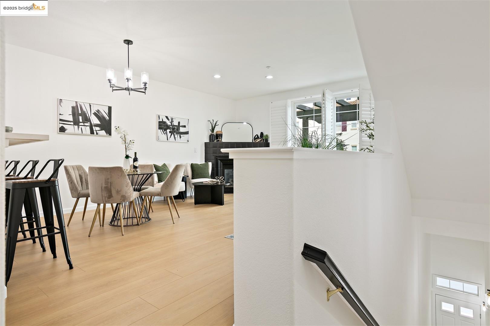 4153 Clarinbridge Circle Dublin, CA 94568 - Photo 8 of 60 Stairway featuring wood finished floors, a chandelier, recessed lighting, and a fireplace
