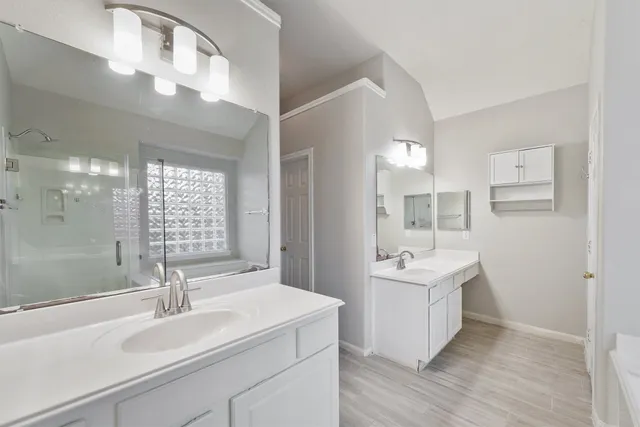 a bathroom with a sink double vanity and a mirror