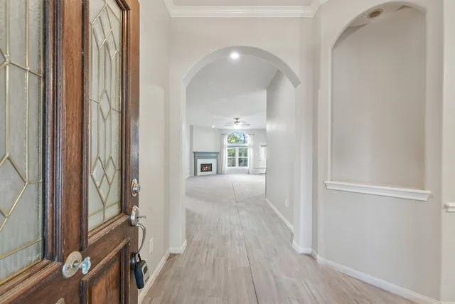 a view of a hallway with wooden floor and staircase