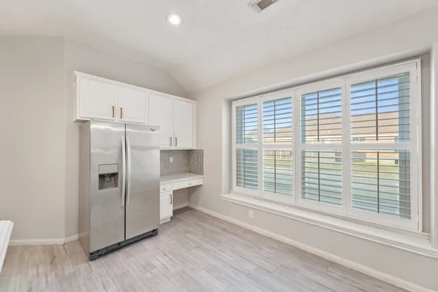 a kitchen with stainless steel appliances a refrigerator sink and cabinets