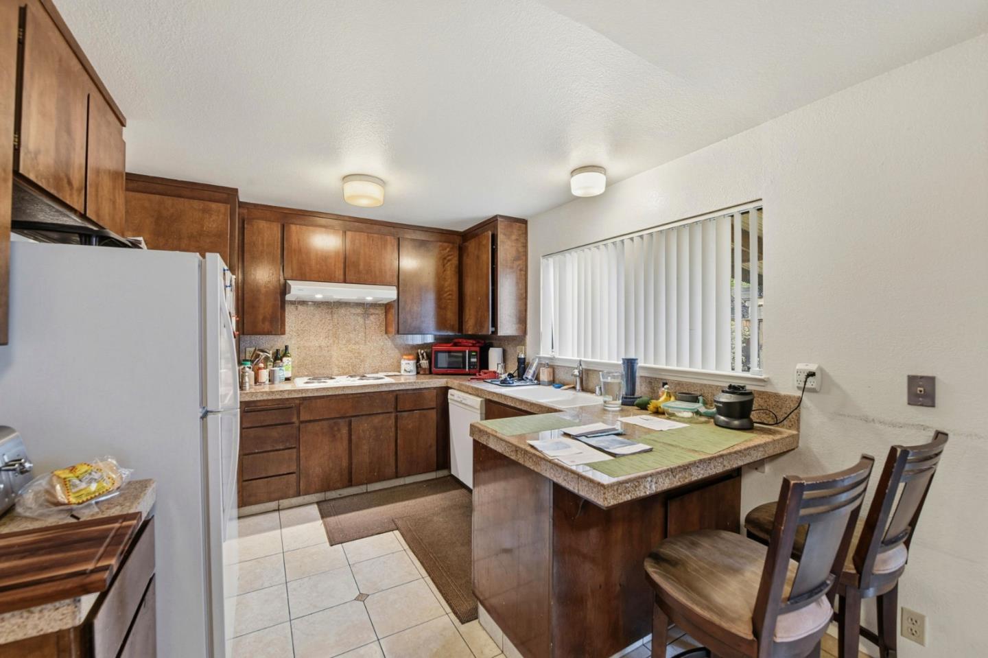 1349 Coniston Court San Jose, CA 95118 - Photo 11 of 55 a kitchen with a stove a sink and a refrigerator