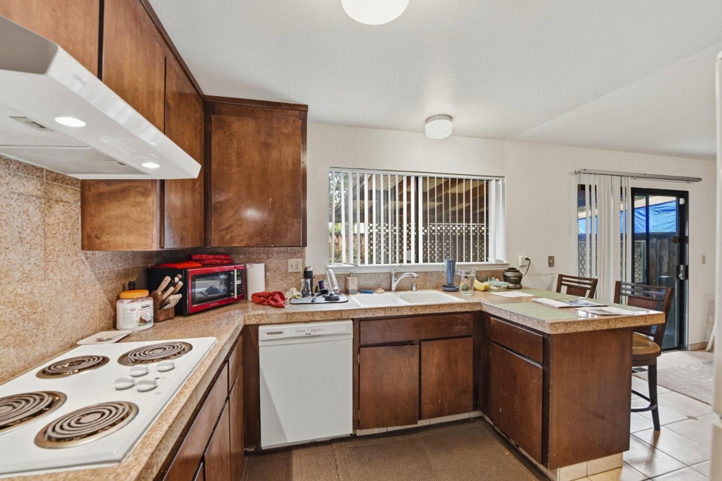 1349 Coniston Court San Jose, CA 95118 - Photo 13 of 55 a kitchen that has a sink a stove and wooden cabinets