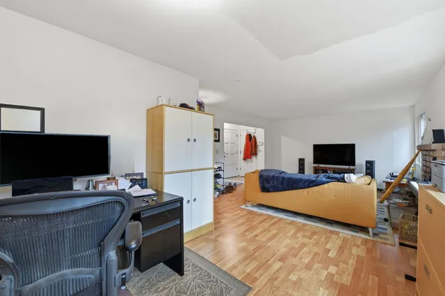 a bedroom with furniture and a flat screen tv
