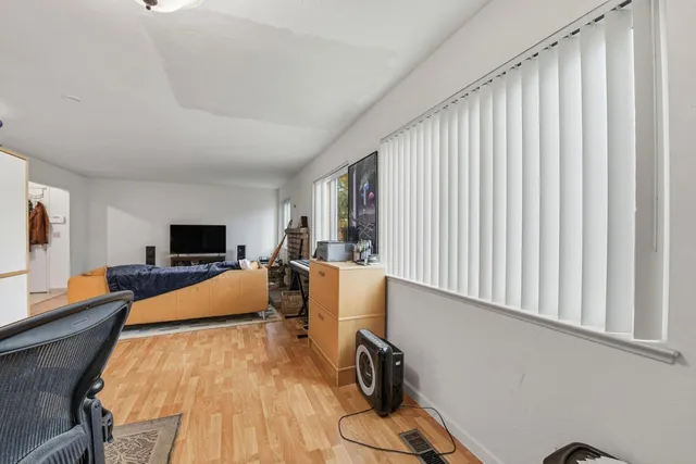 a bedroom with a bed and window