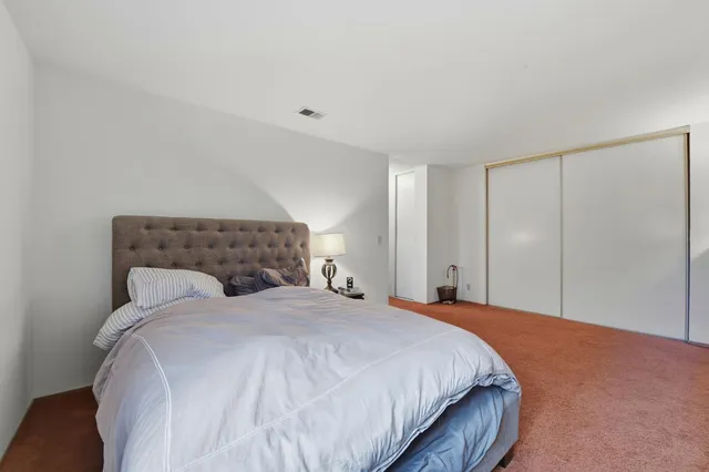 a bed room with a bed and a window