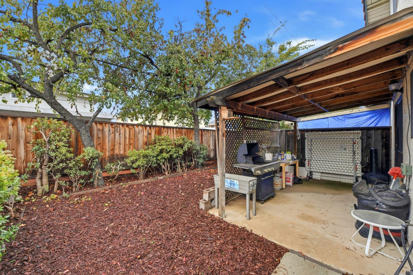 1349 Coniston Court San Jose, CA 95118 - Photo 30 of 55 a view of a backyard with table and chairs and a large tree