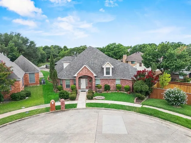 a view of house with a big yard and a large tree