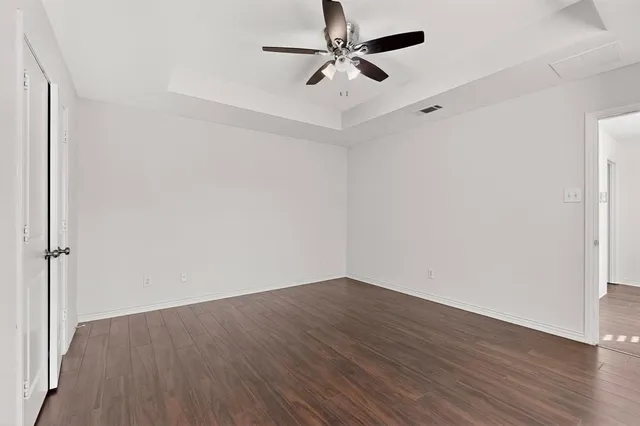 an aerial view of a house with a yard and lake view