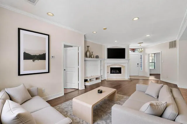 an empty room with wooden floor and a fireplace