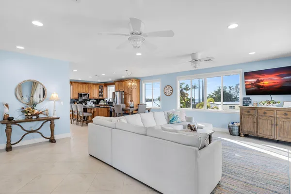a living room with furniture and a view of kitchen